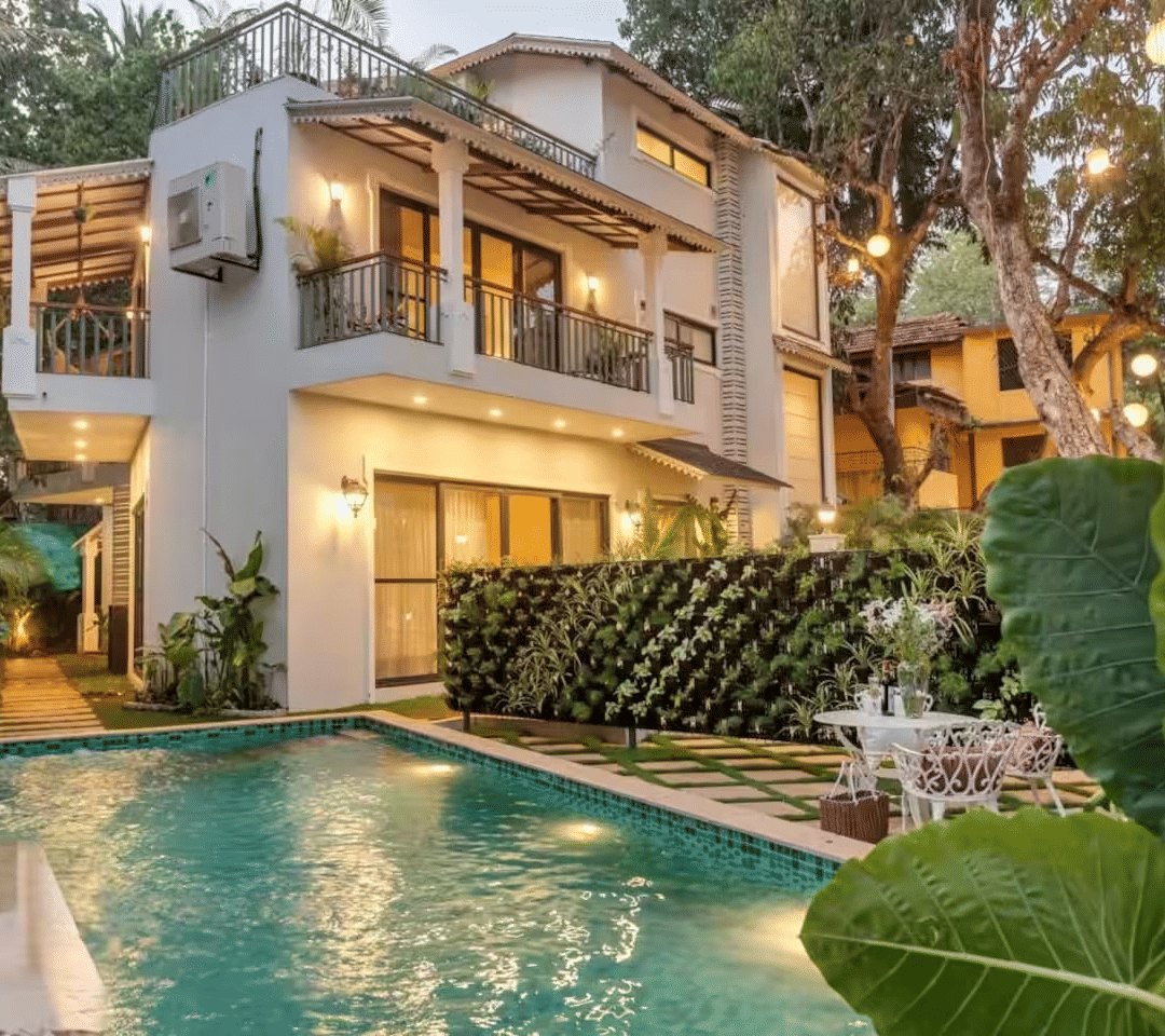 Exterior view of the villa with a pool surrounded by lush plants at Lime Tree Villa with Private Pool | Luxury Stay in Goa.